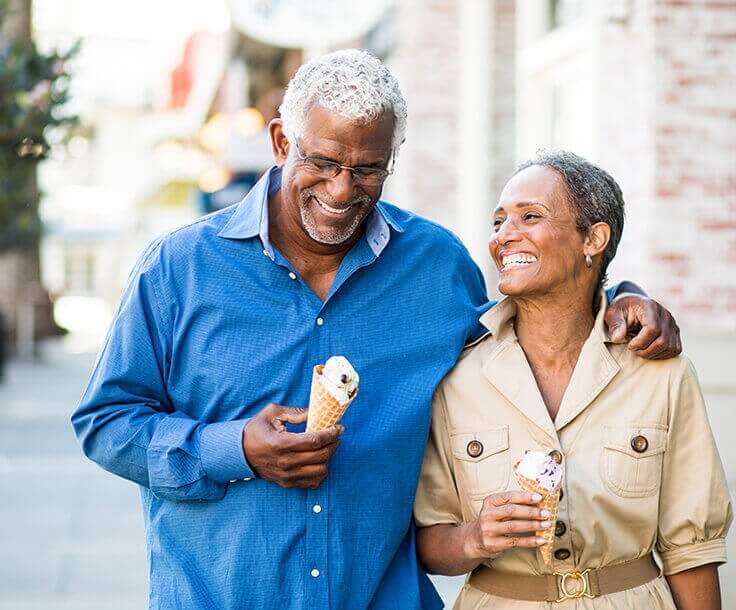 happy senior couple eating ice cream together