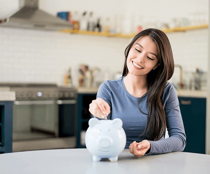 woman saving money in piggy bank