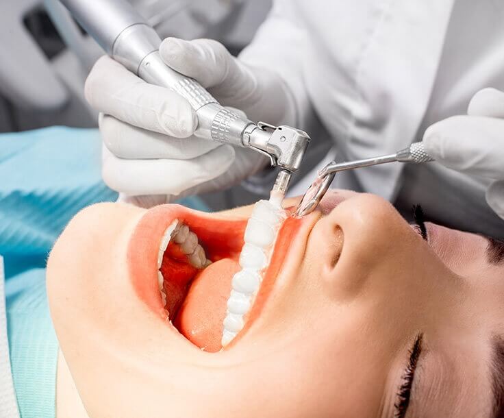 dentist examining a woman's teeth
