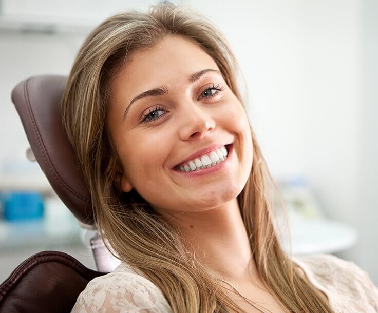 smiling woman sitting in a dental chair